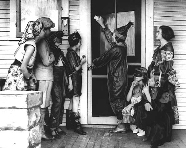 Halloween trick-or-treaters wait on porch in 1934