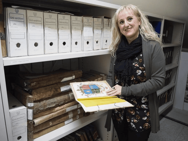 Female historian holding yearbook